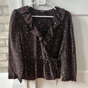 Madewell ruffle, wrap blouse. Mostly black with mult-colored stars.